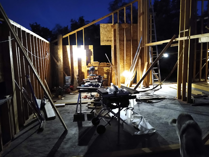 Night work on framing showing active jobsite progress